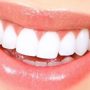Beautiful young woman teeth and lips. Close up
